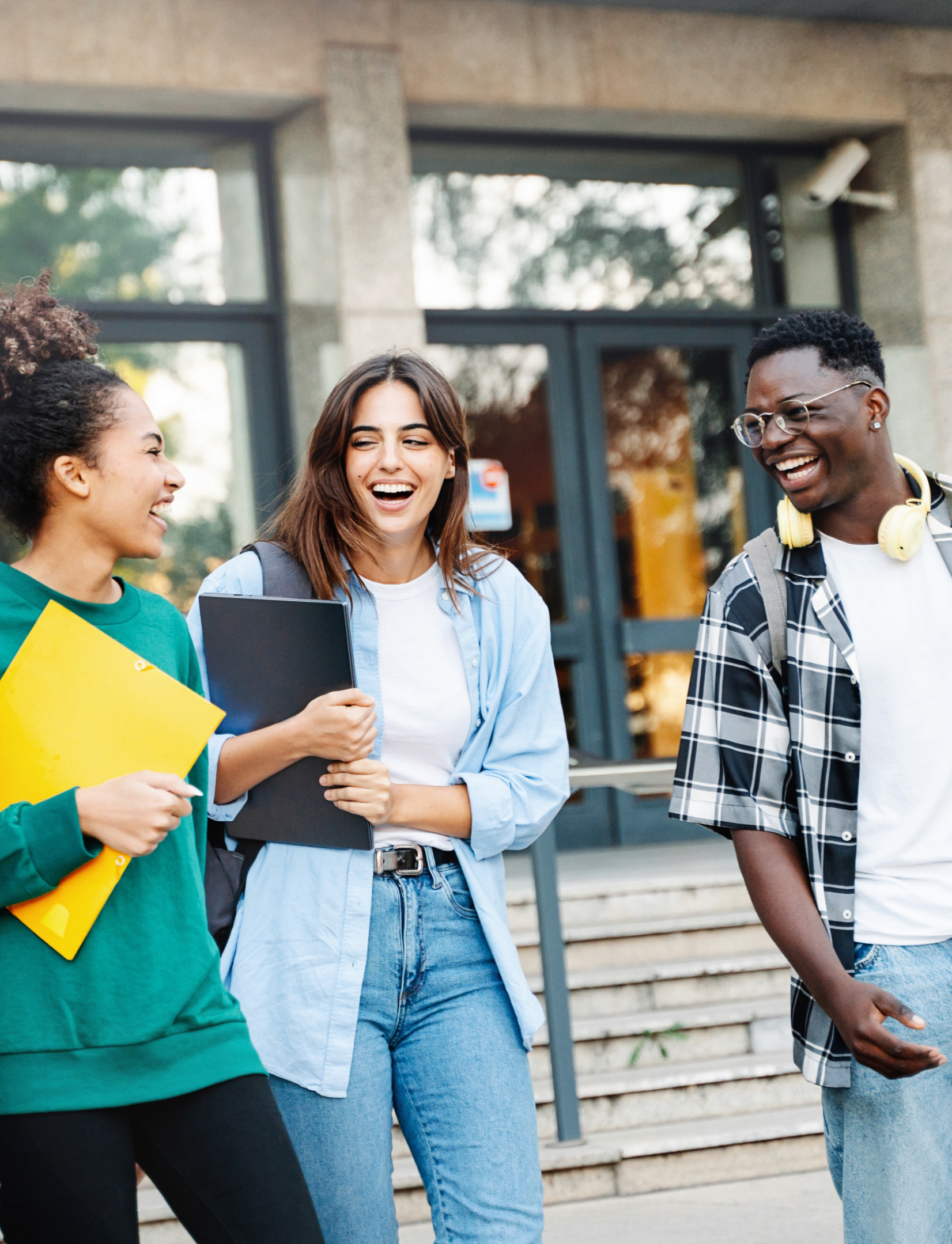 3 students talking and smiling